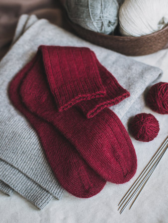 Hand knitted socks with needles and yarn ball. Concept for handmade and hygge slow life.の写真素材