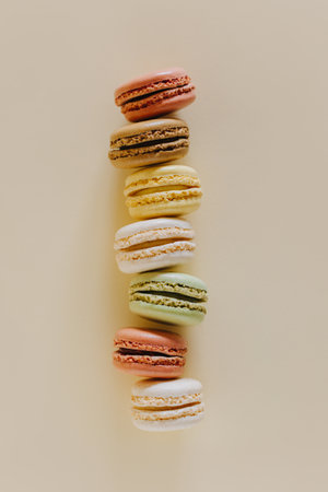 Tasty french macarons on a peach pastel background. Place for text. flat lay.の写真素材