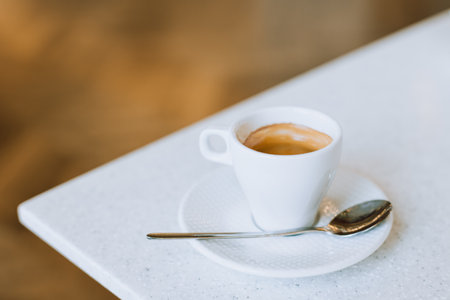 Cup of black coffee on a table in a cafe. Place for text.の写真素材