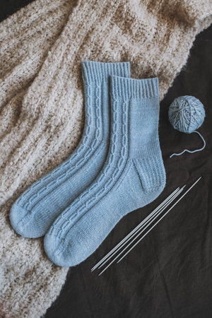 Hand knitted socks with needles and yarn balls. Concept for handmade and hygge slow life.の写真素材