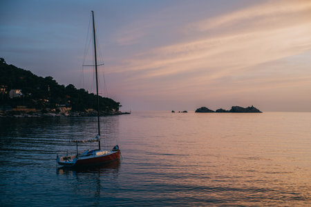 Beautiful red boat at sunset in the sea near Dubrovnik city, Croatia. Travel destination in Croatia.の写真素材