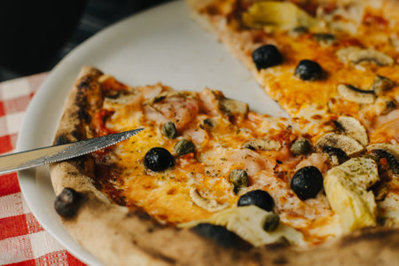Delicious pizza Margarita in a traditional Italian pizzeria. Selective focus. Close-up.の写真素材