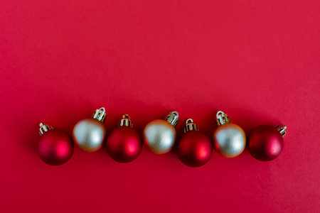 Beautiful Christmas ornaments on a bright red background with stars. Flat lay. Place for text.の写真素材