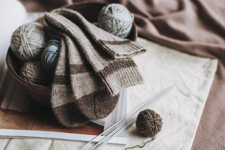 Hand knitted socks with needles and yarn ball in a basket. Concept for handmade and hygge slow life.の写真素材