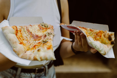 Girl with delicious Italian pizza in her hands. Selective focus.の写真素材