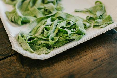 Freshly prepared Italian spinach pasta. Close-up. Selective focus.