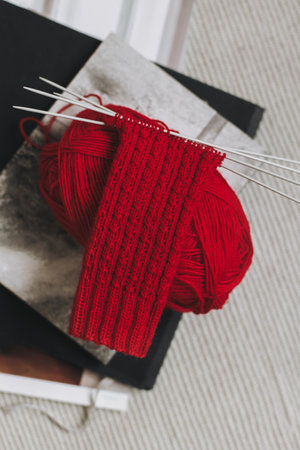 Hand knitted socks with needles and yarn ball. Concept for handmade and hygge slow life.