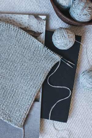 Hand knitting with needles and yarn ball. Concept for handmade and hygge slow life.