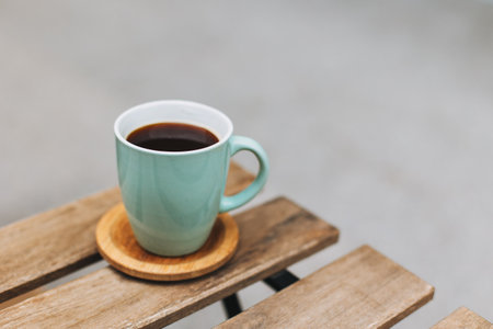 Cup of black coffee on a table in a street cafe. Place for text.の写真素材