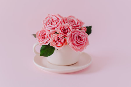 Beautiful bouquet of pink Rose flowers on a pink pastel background. Place for text.の写真素材