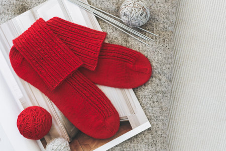 Hand knitted socks with needles and yarn ball. Concept for handmade and hygge slow life.