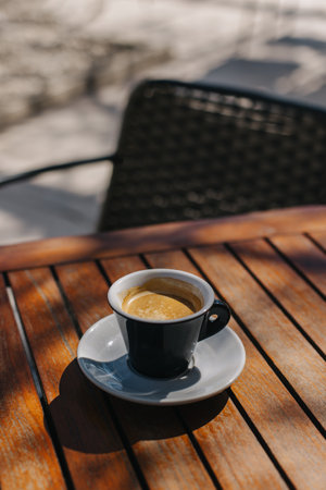 Cup of black coffee on a table in a street cafe. Place for text.の写真素材