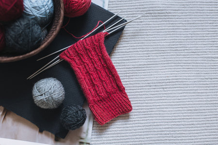 Hand knitted socks with needles and yarn ball. Concept for handmade and hygge slow life.の写真素材