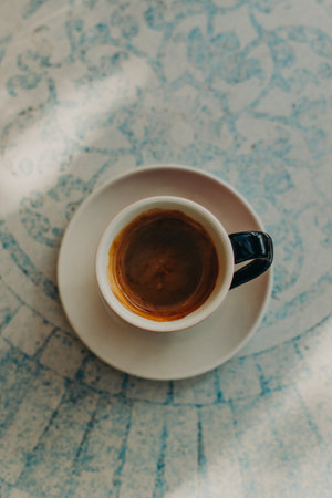 Cup of black coffee on a table in a cafe. Top view. Place for text.の写真素材