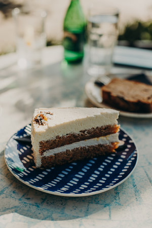 Delicious cake on a plate in a cafe. Daylight. Selective focus. Close up.の写真素材