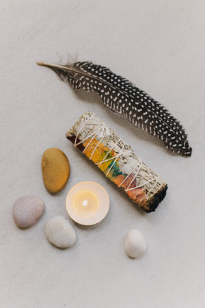 White sage and candle with stones for meditation. Minimalism. Calm and mindfulness. Place for text.の写真素材