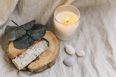 White sage and candle with stones for meditation. Minimalism. Calm and mindfulness. Place for text.の写真素材