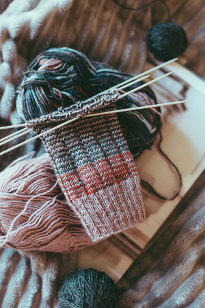 Hand knitted socks with needles and yarn ball. Concept for handmade and hygge slow life.の写真素材
