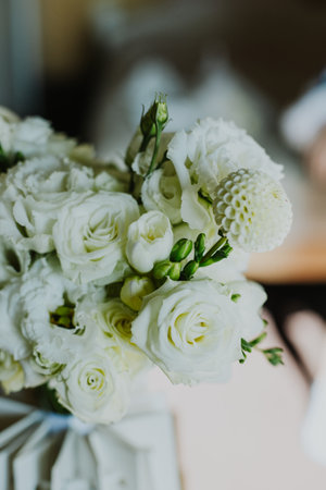 Tender wedding bouquet of white flowers Freesia, Roses in a morning sunlight. Selective focus.の写真素材