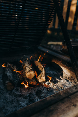 Empty flaming grill with open fire for bbq on a backyard.の写真素材