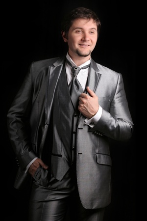 attractive man in the silver business suit on black backgroundの写真素材
