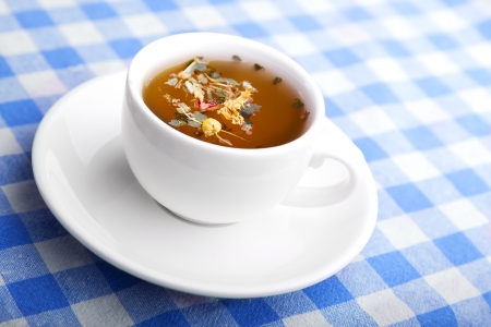 Cup of Herbal healthy Tea on a checkered tableclothの写真素材