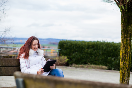 Woman with tablet outdoorの写真素材