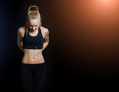 Athletic young woman showing trained beautiful body and pumped abdominalsの写真素材