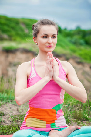 Peaceful healthy & fit young woman meditating on the natureの写真素材