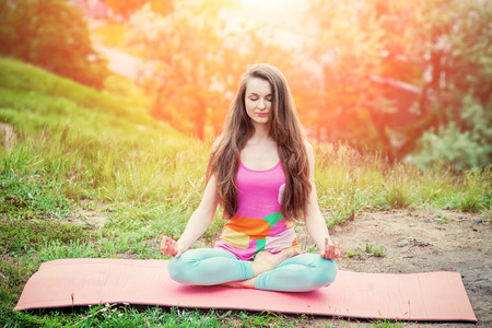 Peaceful Healthy & Fitness Young Woman Meditating on the nature with eyes closedの写真素材