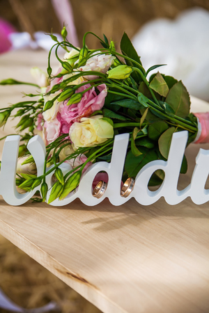 Word of wedding and bridal bouquet outdoorの写真素材