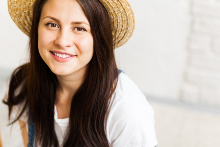 Closeup of happy smiling female artist in a straw hat の写真素材