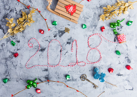 New Year 2018 background with figures, Christmas toys, New Year 2018 composition. Text 2018 made of thread. Flat lay, top view of New Year 2018 festive still lifeの写真素材