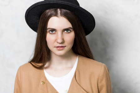 Close up of beautiful young woman with black hat. の写真素材