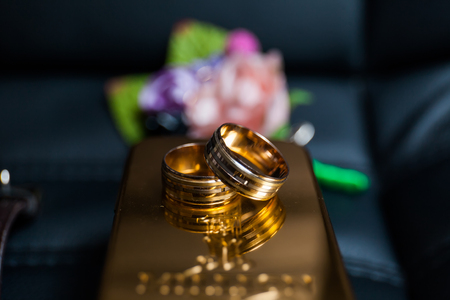 Wedding concept. Close-up of wedding rings with copy space, on the dark backgroundの写真素材