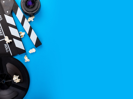 Cinema Film Background Camera With Clapperboard, Tickets, Rolls, Glasses popcorn, lens, reel, film and sodaの写真素材