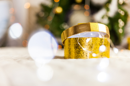 golden round gift boxes sparkling with bow on Christmas backgroundの写真素材