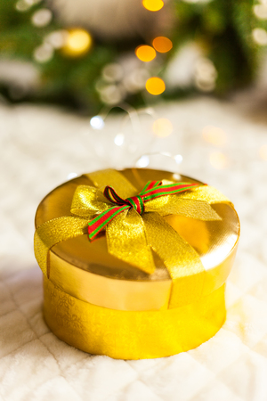 golden round gift boxes sparkling with bow on Christmas backgroundの写真素材