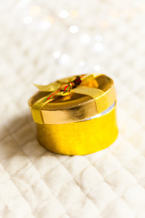 golden round gift boxes sparkling with bow on Christmas backgroundの写真素材