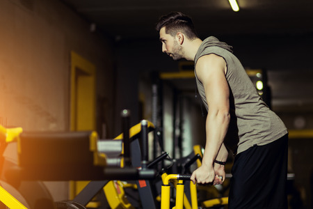 Concept Power Strength Healthy Lifestyle Sport Powerful Muscular man working out in gym doing...