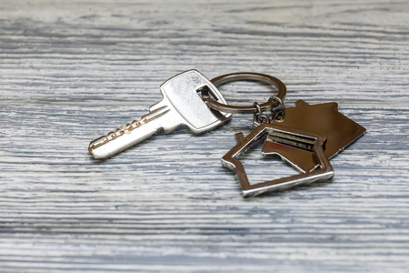 House key with house figure on backgroundの写真素材