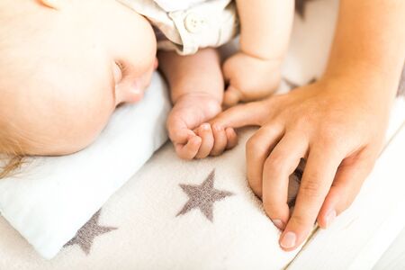 Concept of love and family. hands of mother and baby closeup