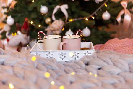 Christmas concept, hot coffee or cocoa candy canes and marshmallows on a wooden tray with snowflakes. Christmas time, copy spaceの写真素材