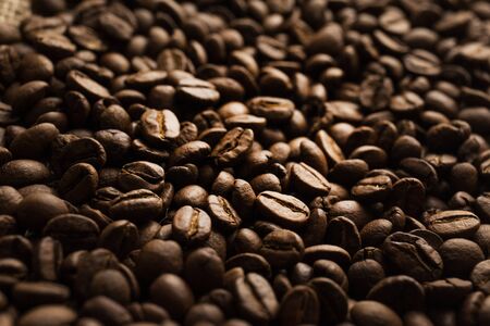 Roasted Arabica beans close up, coffee background