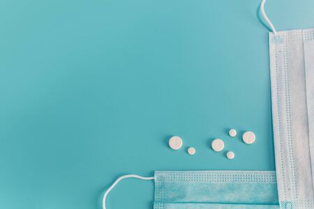 Novel coronavirus disease named 2019 nCoV with breathing mask and pills, selective focus on blue background with Copy spaceの写真素材