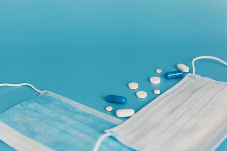 Novel coronavirus disease named 2019 nCoV with breathing mask and pills, selective focus on blue...