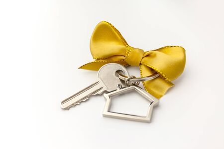 House key with red bow on white backgroundの写真素材
