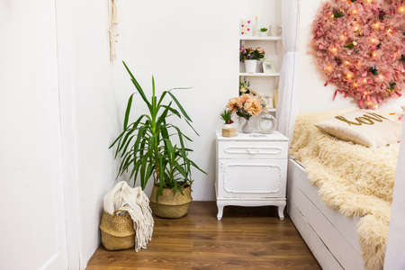 Cozy white wooden romantic bedroom in a four-poster apartment with a large fluffy heart on the wall