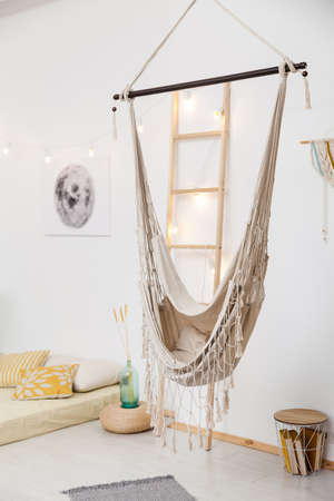 White Living room with low bed and hammock in boho style