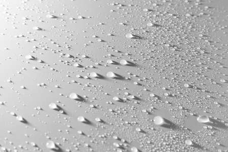 Close up of water drops with shadows on grey tone background. Abstract gray wet texture with bubbles on plastic PVC surface. Realistic pure water droplets condensed. Detail of canvas leather textureの写真素材